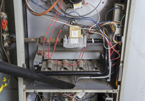 Inside of a home heating unit in the midst of furnace repair services in Portland OR house