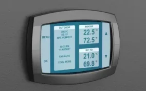 smart thermostat in home displays indoor temperature and outdoor weather data